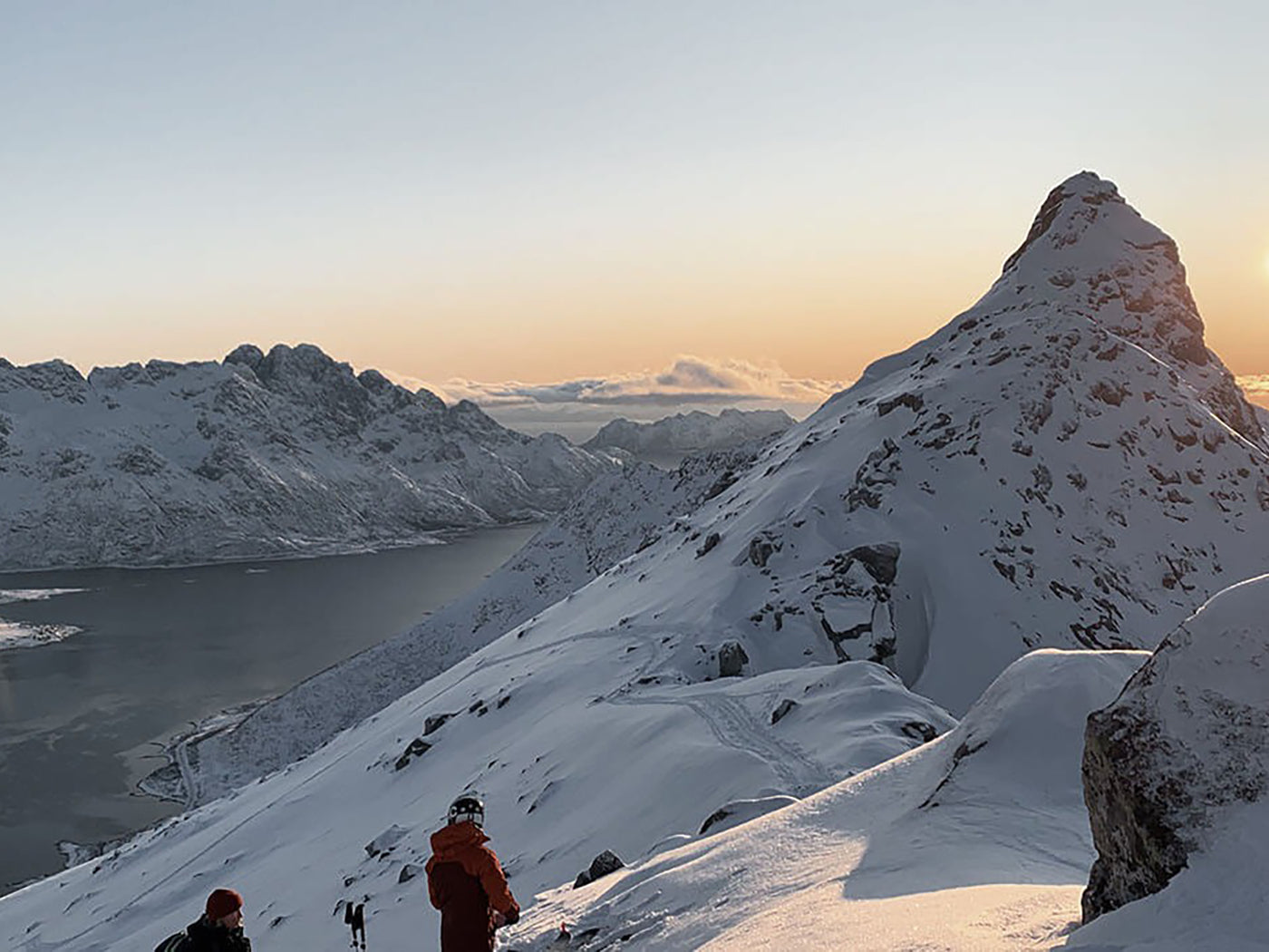 Two people on a snowy mountain in Lofoten, Norway